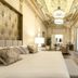 Myr Palacio Vallier in Valencia, elegant suite with ornate ceiling, king bed, and seating area