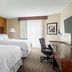 Four Points by Sheraton Buffalo Grove guest room with two beds, desk, chair, and window curtains