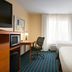 Fairfield Inn and Suites by Marriott Weirton guest room with two beds, desk, TV and window light