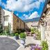 Fence Gate Lodge in Burnley with stone exterior, courtyard seating, and landscaped potted flowers