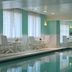 Indoor pool at Hilton Garden Inn Virginia Beach Town Center in Virginia Beach with lounge chairs and windows