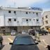 Skudai Baru Hotel in Skudai, white 2-story hotel building with parked cars in front