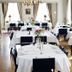 Bofors Hotel in Karlskoga dining room set with white tablecloths and floral centerpieces