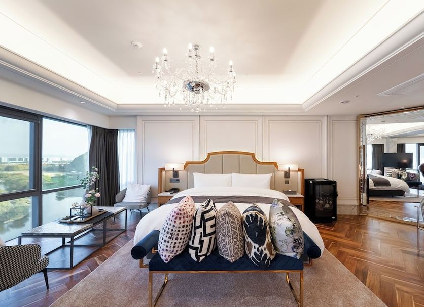 Hotel Inter-Burgo Daegu suite with chandelier, large windows, and city-view seating area