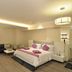 Hotel Vijay Parkinn, Coimbatore guest room with king bed, sofa, desk, and warm lighting