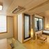 Kamenoi Hotel Yanagawa room in Yanagawa with twin beds, seating area, and balcony door