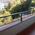 Hotel Glavjc, Torno balcony with lake and hillside view, white table and chairs