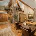 Faraway Jackson Hole in Teton Village: rustic lodge lobby with stone fireplace, wood beams, and spiral staircase