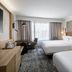 Sheraton Nashville Brentwood guest room with two beds, desk, and large window in Brentwood