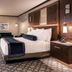 Resorts World Catskills in Monticello guest room with king bed, seating area and patterned carpet