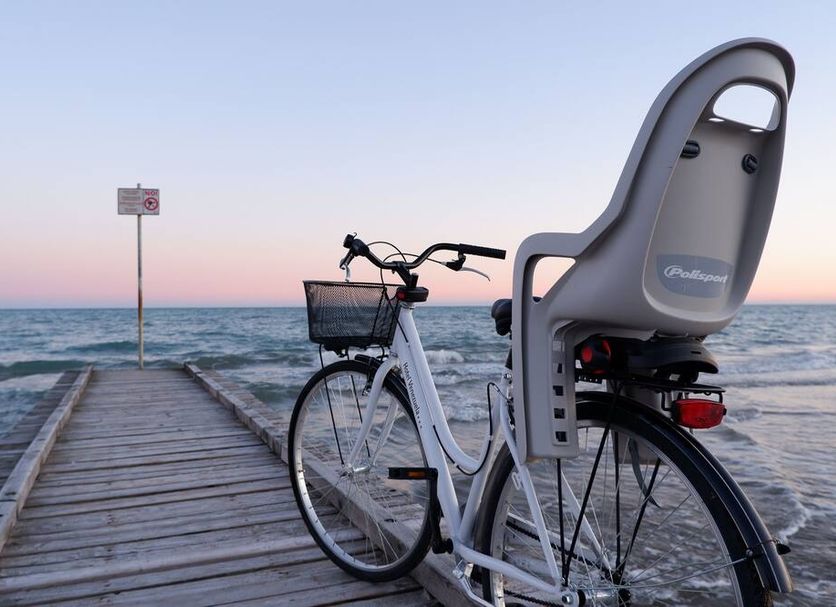 Hotel Venezuela in Jesolo: bicycle parked on a wooden pier by the sea at sunset