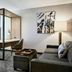SpringHill Suites by Marriott Phoenix Goodyear suite with bed, desk, sofa, and modern room divider
