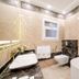 Arabella Residence Cairo bathroom with freestanding tub, bidet, sink, and marble tile accents