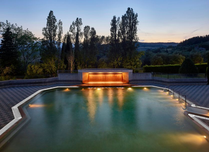 Fonteverde Lifestyle & Thermal Retreat in San Casciano Dei Bagni, illuminated outdoor thermal pool at dusk