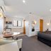 Knightsbridge Court Motor Lodge in Blenheim: studio room with bed, kitchenette, table and seating
