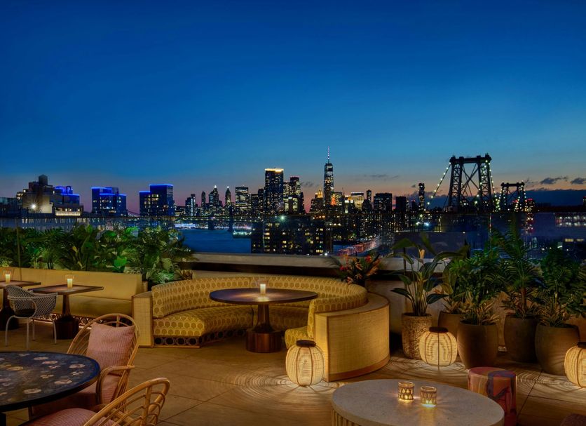 Rooftop lounge at Moxy Brooklyn Williamsburg with skyline views over Brooklyn at dusk