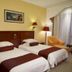 Gold River Side Hotel Jiaxing twin room with two beds, wall lamps, and an armchair
