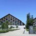 Sky Hotel in Matsuyama with modern triangular-roofed exterior, trees, and gated entrance