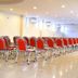 Hotel The Great Ananda in Haridwar meeting hall with rows of red chairs and polished floor