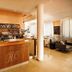 Hc Resort in Lignano Sabbiadoro lobby bar with wooden counter, seating area and large windows