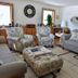 Lakeside Bed & Breakfast in Florence living room with sofa, armchairs, ottoman, and large windows