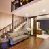 The Deer Park Hotel, Giritale: spacious lounge with staircase, sofa, and indoor view to garden area
