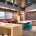Tru by Hilton Clearfield Hill Air Force Base lobby seating area with colorful chairs and communal tables