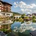Hotel Bareiss in Baiersbronn with reflective garden pool, lounge chairs, and mountain views