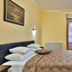 Hotel Stella di Mare in Bečići guest room with double bed, balcony doors, and wardrobe