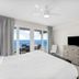 Laketown Wharf 1712 in Panama City Beach bedroom with ocean-view balcony and TV