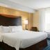 Fairfield Inn and Suites by Marriott Weirton guest room with king bed and bright window