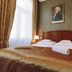 Mozart Hotel Szeged guest room with double bed, bedside lamps and portrait above the headboard