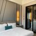 Görükle Güler Park Hotel room with bed and black-framed glass bathroom door in Görükle