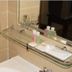 Jb City Hotel in Johor Bahru bathroom sink with mirror, glass shelf, and toiletries