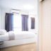 Vanilla Residence Chiangmai in Chiang Mai: bright bedroom with bed, curtains, air conditioner and open shelves