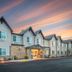 Aristocrat Hotel, BW Signature Collection in Half Moon Bay exterior at sunset with lit entrance