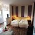 Gästehaus Seewarte Flensburg guest room with twin beds, glass coffee table and large windows