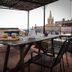 Casa Giuliana in Lipari: terrace dining table with chairs and town views under a pergola
