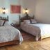 Hotel del Vasco in Zacatecas room with two wrought-iron beds and wall sconces