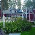 Örnvik Hotell & Konferens in Luleå with red cabins, a garden path, and pine trees