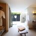 Arennas Mancora in Máncora spa bathroom with open shower, vanity, robes, and outdoor light