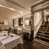 Hospes Puerta de Alcalá, Madrid: elegant hotel dining room with set tables beside a staircase