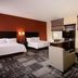Hampton Inn & Suites Phoenix Chandler-Fashion Center room with two beds, seating area, and window AC in Chandler