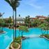 Guangzhou Phoenix City Hotel in Guangzhou with a lagoon-style pool, palm trees, and tropical landscaping