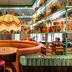 Quality Hotel The Reef in Frederikshavn, colorful restaurant seating with round table and decorative shelves