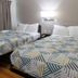 Motel 6 Lufkin room with two beds, wall light, and window curtains