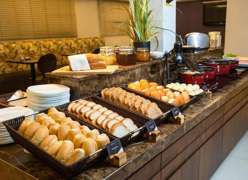 Breakfast buffet at Goldmen Business Joinville in Joinville with breads, rolls, and boiled eggs