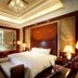 Guanyuan Liusu Hotel in Suzhou bedroom with king bed, ornate ceiling light, and warm wood decor
