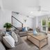 Noosa Outrigger Beach Resort in Noosa Heads living room with open doors to a balcony and tropical view
