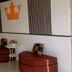 The Loom Rangsit lobby seating area with orange crown wall art in Pathum Thani